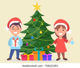 Merry Christmas and a Happy New Year greeting card. Boy and girl in Santa Claus hats standing near decorated Christmas tree with gift boxes under it. Vector illustration.