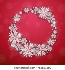 Merry Christmas and Happy New Year greeting card with silver glittering snowflakes wreath on red background