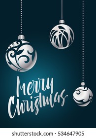 Merry Christmas lettering. Hand written Merry Christmas poster. Modern hand lettering on a turquoise background with silver Christmas balls