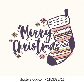 Merry Christmas lettering handwritten with elegant calligraphic script and decorated with knitted stocking or sock and snowflakes. Decorative festive inscription. Colored vector illustration.