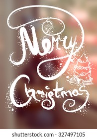 Merry christmas. lettering on the blurred background for design