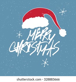 Merry Christmas Lettering. Red letters on blue textured background. With snowflakes and Santa`s hat.