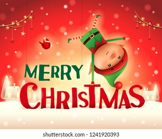 Merry Christmas! Little elf standing on his arm in Christmas snow scene winter landscape. 