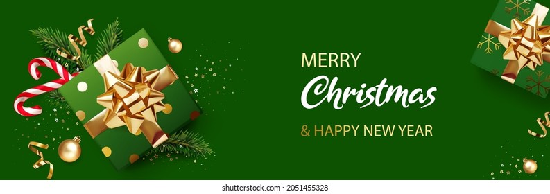 Merry Christmas and New Year banner, horizontal poster. Green Xmas background with gifts, glitter golden confetti, branches of Christmas tree, golden ball and red Xmas candy canes. Realistic vector