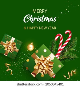 Merry Christmas and New Year banner. Green Xmas background with gifts, glitter golden confetti, branches of Christmas tree, golden ball and red Xmas candy canes. Realistic vector illustration.