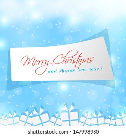Merry Christmas paper note over blue frozen background. 