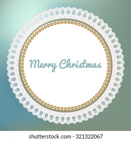Merry Christmas postcard with white lace doily on a blue bokeh fog background.