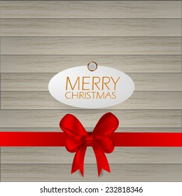 Merry Christmas with red ribbon  paper Cut on wood background 