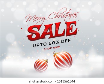 Merry Christmas Sale banner or poster design with 50% discount offer and baubles on snowy shiny blur background.