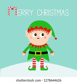 Merry Christmas. Santa Claus Elf standing on snowdrift. Green hat. Happy New Year. Cute cartoon funny kawaii baby character. Flat design Blue background. Vector illustration