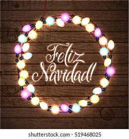 Merry Christmas Spanish Language. Glowing Christmas Lights Wreath for Xmas Holiday Greeting Card Design. Wooden Hand Drawn Background.