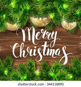 Merry Christmas. Template vector card. Calligraphy. Lettering. Fir tree with balls on the wood table.