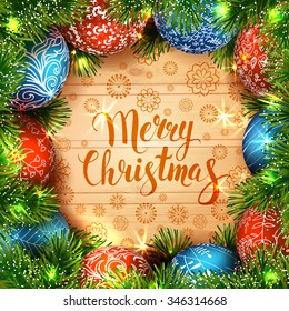 Merry Christmas. Template vector card. Calligraphy. Lettering. Fir tree with blue and red balls on the wood table.