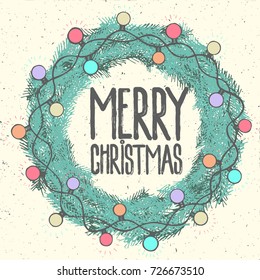 Merry Christmas text in green pine fir wreath on vintage background bright sparkling garland glowing light  