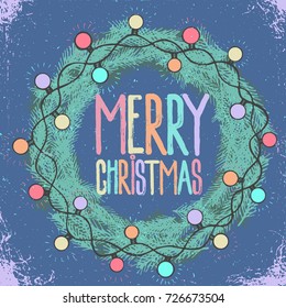 Merry Christmas Text In Pine Fir Wreath Blue Background Bright Sparkling Garland Glowing Light  