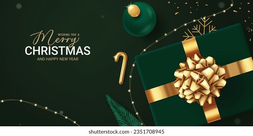 Merry christmas text vector design. Christmas gift box, balls and xmas lights decoration elements in elegant emerald green background. Vector illustration holiday season greeting card.
