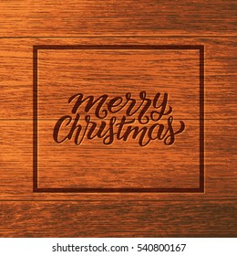 Merry Christmas typographic text in frame on wooden background. Vintage vector greeting card design with hand lettering for winter holidays