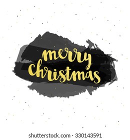 Merry Christmas typography lettering on a isolatedblack watercolor brush strokes and gold ink spots