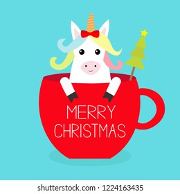 Merry Christmas. Unicorn horse sitting in red coffee cup teacup. Fir tree. Red bow. Happy New Year. Face and hands. Cute cartoon character. Hello winter Blue background Flat design Vector illustration