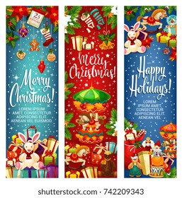 Merry Christmas wish and greeting banners for winter happy holiday card. Vector gifts under Christmas tree, New Year decoration of golden bell and star, holly wreath and candle with gingerbread cookie