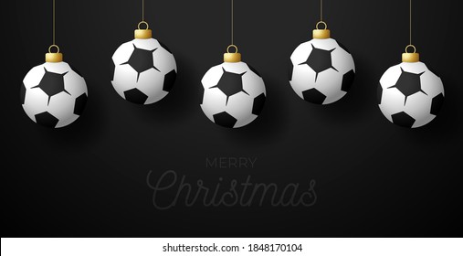 Merry Christmas world Football cup greeting card. Hang on a thread Soccer ball as a Christmas ball on black horizontal background. Sport Vector illustration.