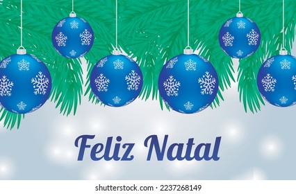 Merry Christmas Written in Portuguese with Blue Realistic Christmas Balls and Green Tree Branches in White Bokeh Background