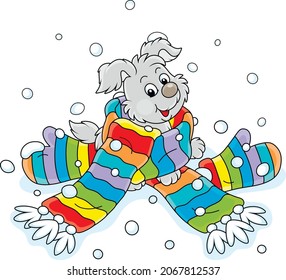 Merry little pup playing in a long colorful striped scarf and mittens, vector cartoon illustration isolated on a white background