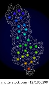 Mesh vector map of Albania with glare effect. Light spots have bright spectrum colors. Abstract lines, triangles, light spots and points on a dark background with map of Albania.