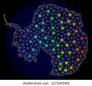Mesh vector map of Antarctica continent with glare effect. Light spots have bright spectrum colors. Abstract lines, triangles,