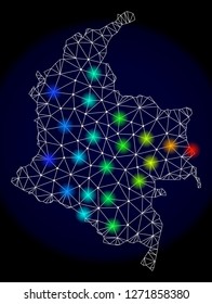 Mesh vector map of Colombia with glare effect. Light spots have bright spectrum colors. Abstract lines, triangles, light spots and points on a dark background with map of Colombia.