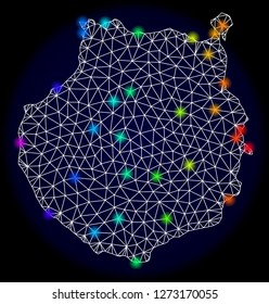 Mesh vector map of Gran Canaria with glare effect. Light spots have bright spectrum colors. Abstract lines, triangles, light spots and points on a dark background with map of Gran Canaria.