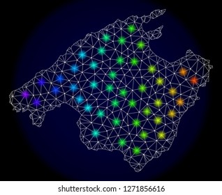 Mesh vector map of Mallorca with glare effect. Light spots have bright spectrum colors. Abstract lines, triangles, light spots and points on a dark background with map of Mallorca.