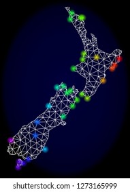 Mesh vector map of New Zealand with glare effect. Light spots have bright spectrum colors. Abstract lines, triangles, light spots and points on a dark background with map of New Zealand.