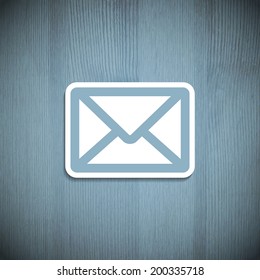 Message icon on a wooden background. Vector