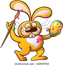 Messy an talented yellow Easter rabbit getting paint on his body while having fun decorating an Easter egg