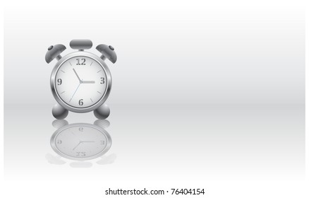 Metal alarm clock with a reflection on a gray background