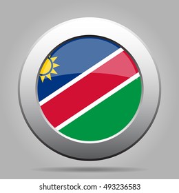 metal button with the national flag of Namibia on a gray background