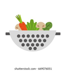 Metal kitchen strainer with vegetables