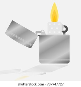 metal lighter with burning flame on grey background with shadow on glass
