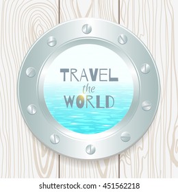 metal porthole with seascape on wooden background