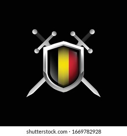 escudo metálico belga con dos espadas cruzadas.aislado sobre fondo negro.
