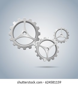 Metallic cogwheels with brushed surface and three spokes isolated on blue background