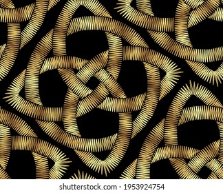 Metallic embroidery seamless pattern on a black background. Golden celtic pattern. Irish ornament for decoration