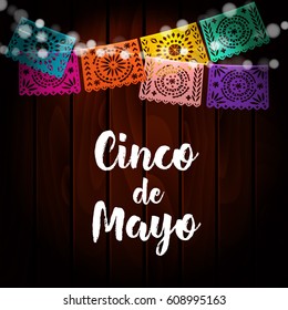 Mexican Cinco de Mayo greeting card, invitation. Party decoration, string of lights, handmade cut paper flags. Old wooden background. Vector illustration.