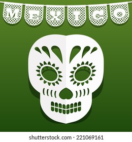 mexican decoration with traditional papel picado (cut paper) bunting and paper skull