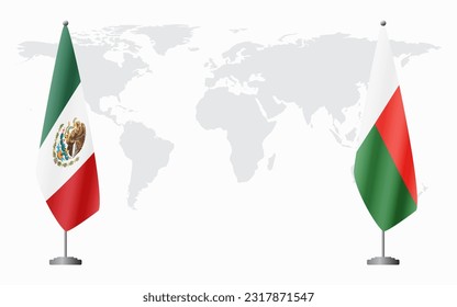 Mexico and Madagascar flags for official meeting against background of world map.