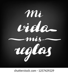 Mi vida mis reglas, vector hand lettering. Translation from Spanish of phrase my life my rules. Calligraphic inspirational inscription. Chalkboard blackboard lettering writing handwritten text.