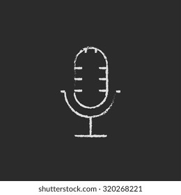 Microphone hand drawn in chalk on a blackboard vector white icon isolated on a black background.