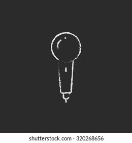 Microphone hand drawn in chalk on a blackboard vector white icon isolated on a black background.