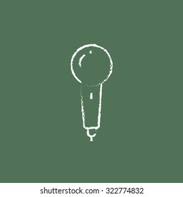 Microphone hand drawn in chalk on a blackboard vector white icon isolated on a green background.